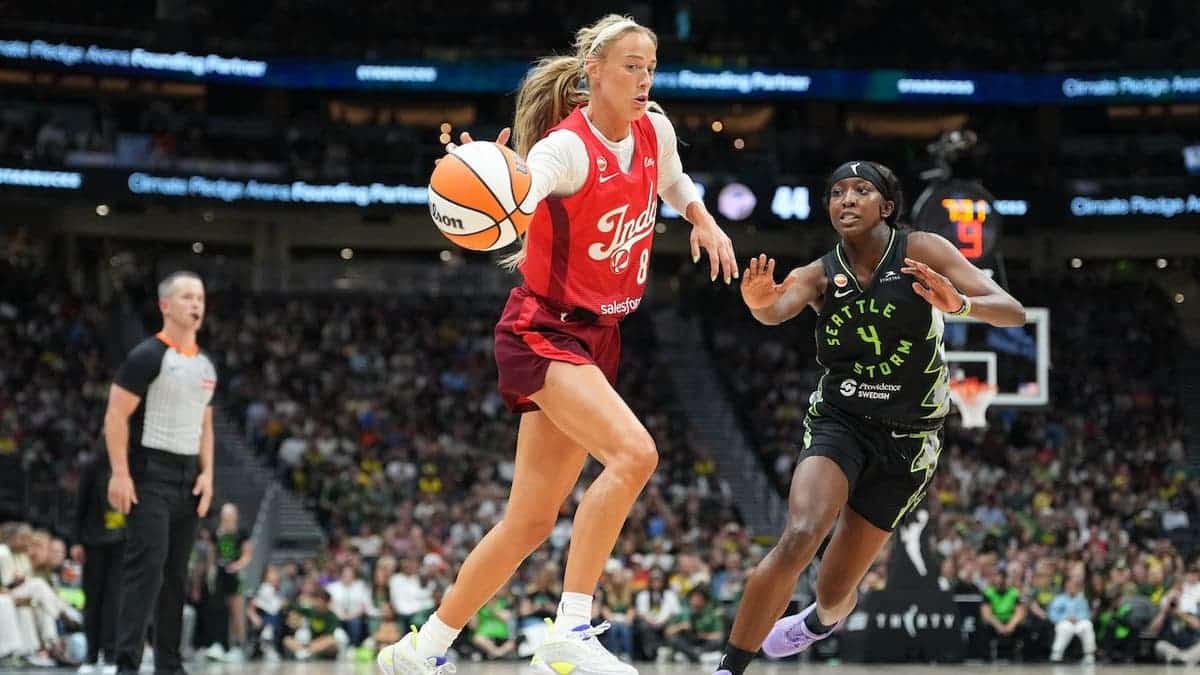 Sophie Cunningham of the Indiana Fever handles the ball against Flau'jae Johnson of the Seattle Storm.