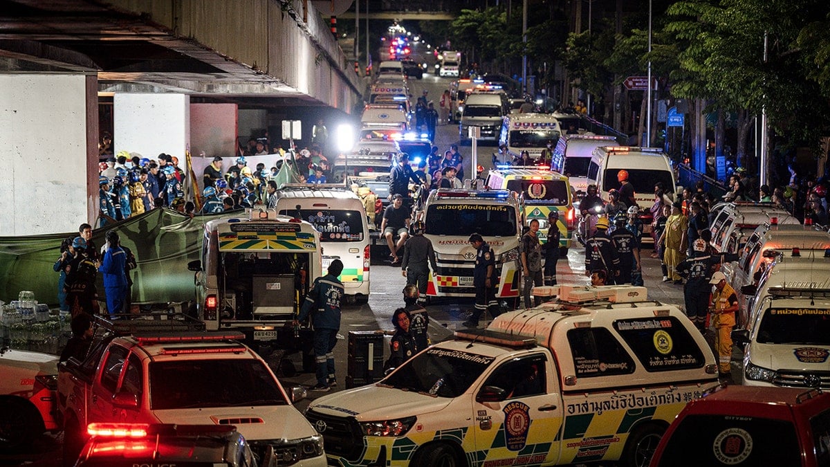 An ambulance is parked outside a bar after a massive fire broke out in Bangkok
