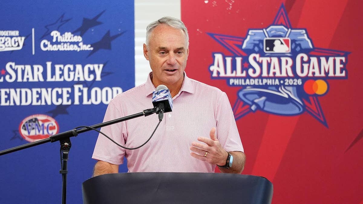 Robert Manfred speaks at a podium during an event