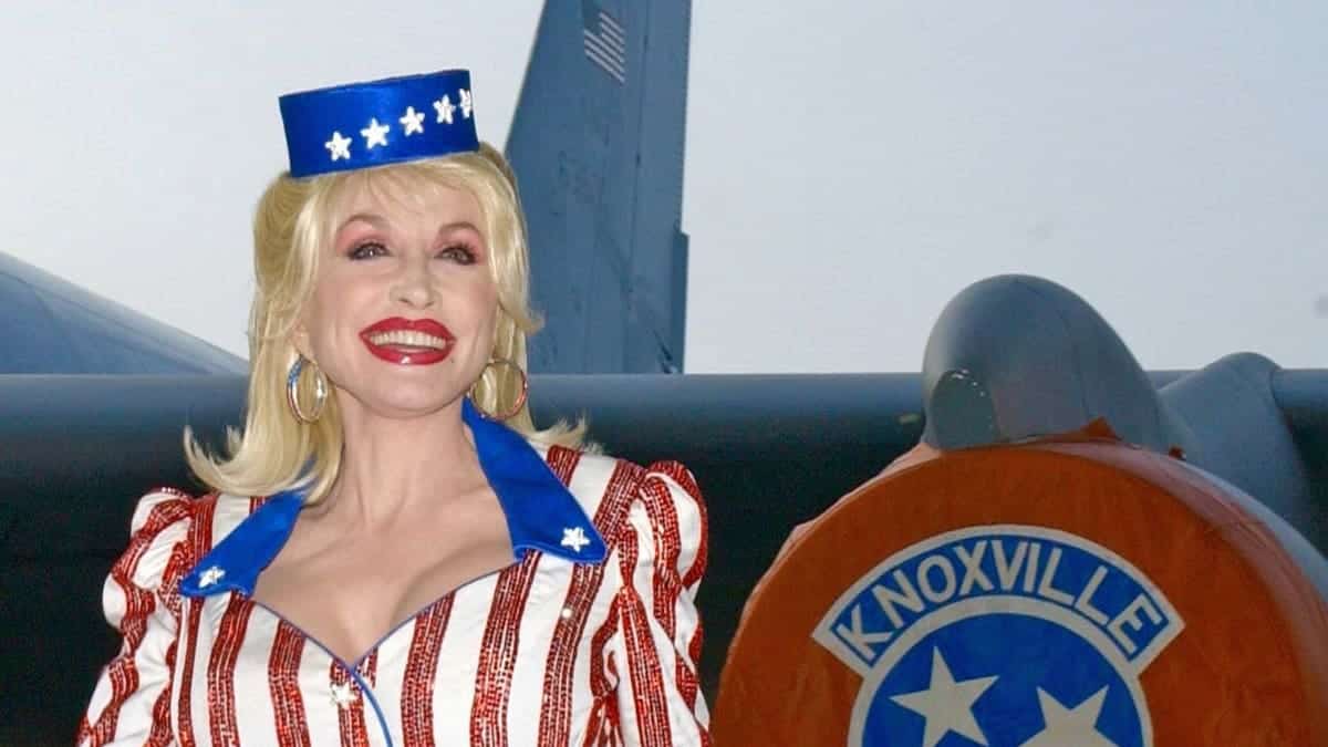 Dolly Parton poses with military aircraft bearing her likeness