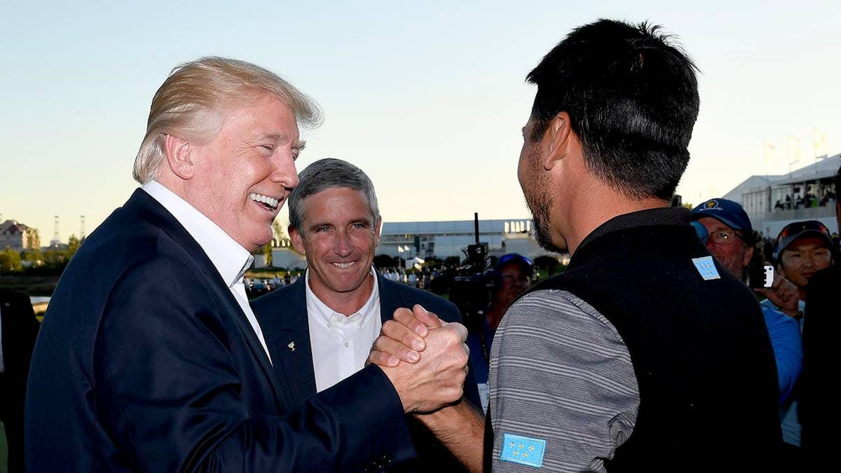 President Donald Trump shakes hands with Jason Day at the Presidents Cup.