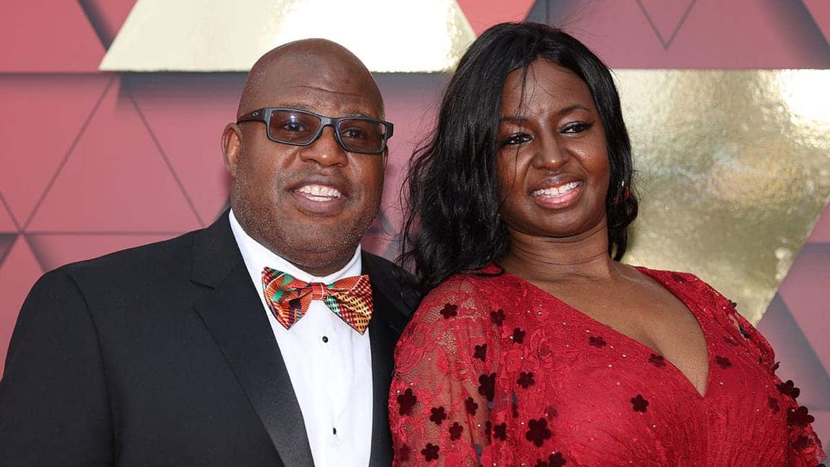Eric Bieniemy and his wife Mia stand on a red carpet in Kansas City