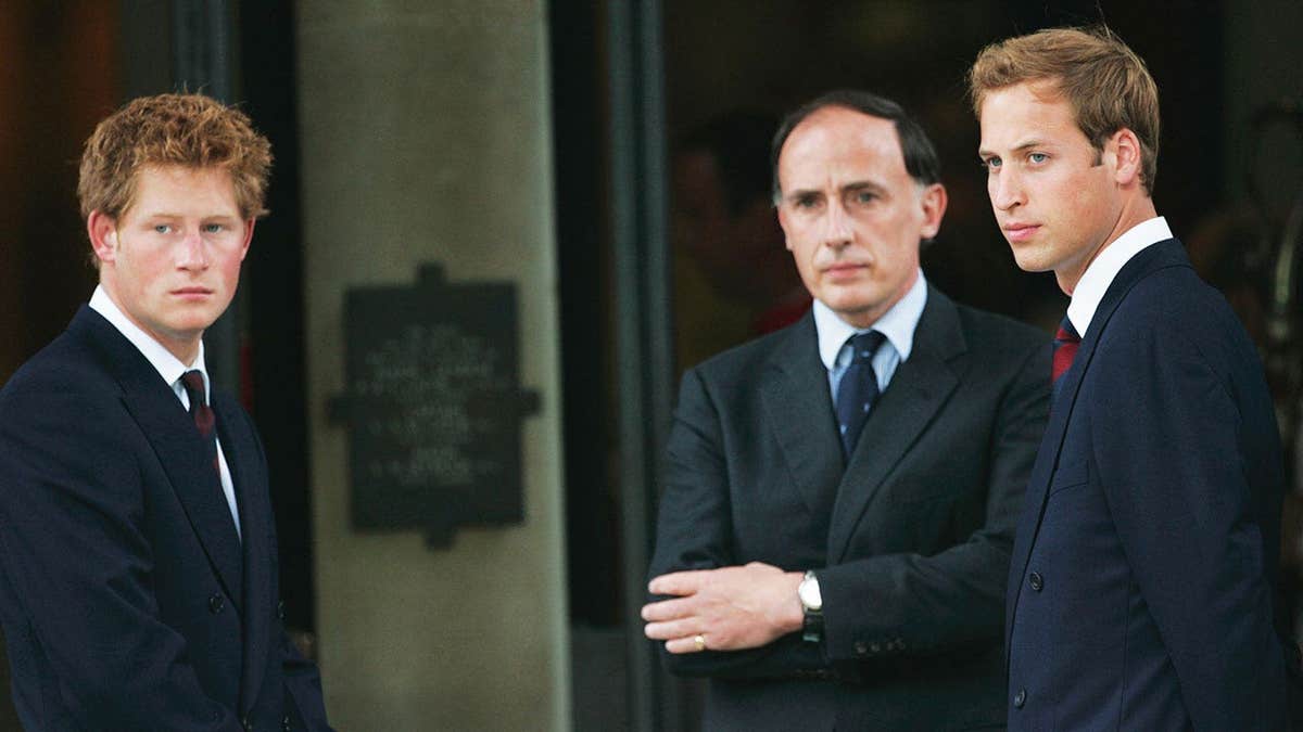 Jamie Lowther-Pinkerton speaking to Prince Harry and Prince William in dark suits.