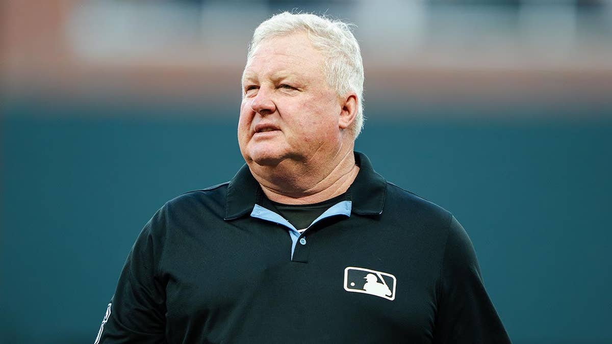 Umpire Bill Miller stands on the field at Truist Park