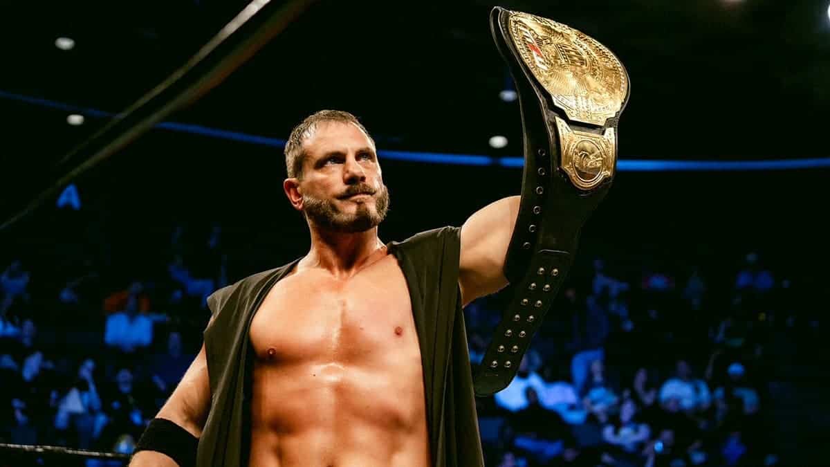 Austin Aries holds the title up