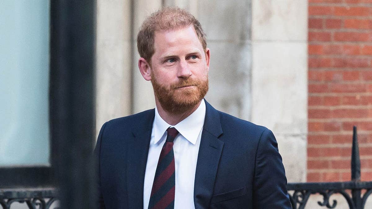 Prince Harry in a dark suit leaving London's High Court.