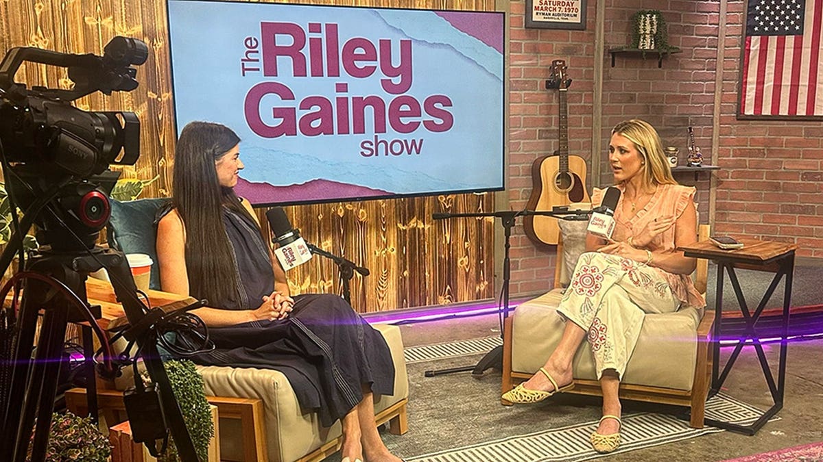 Madison Prewett and Riley Gaines sit across from each other during a podcast interview.