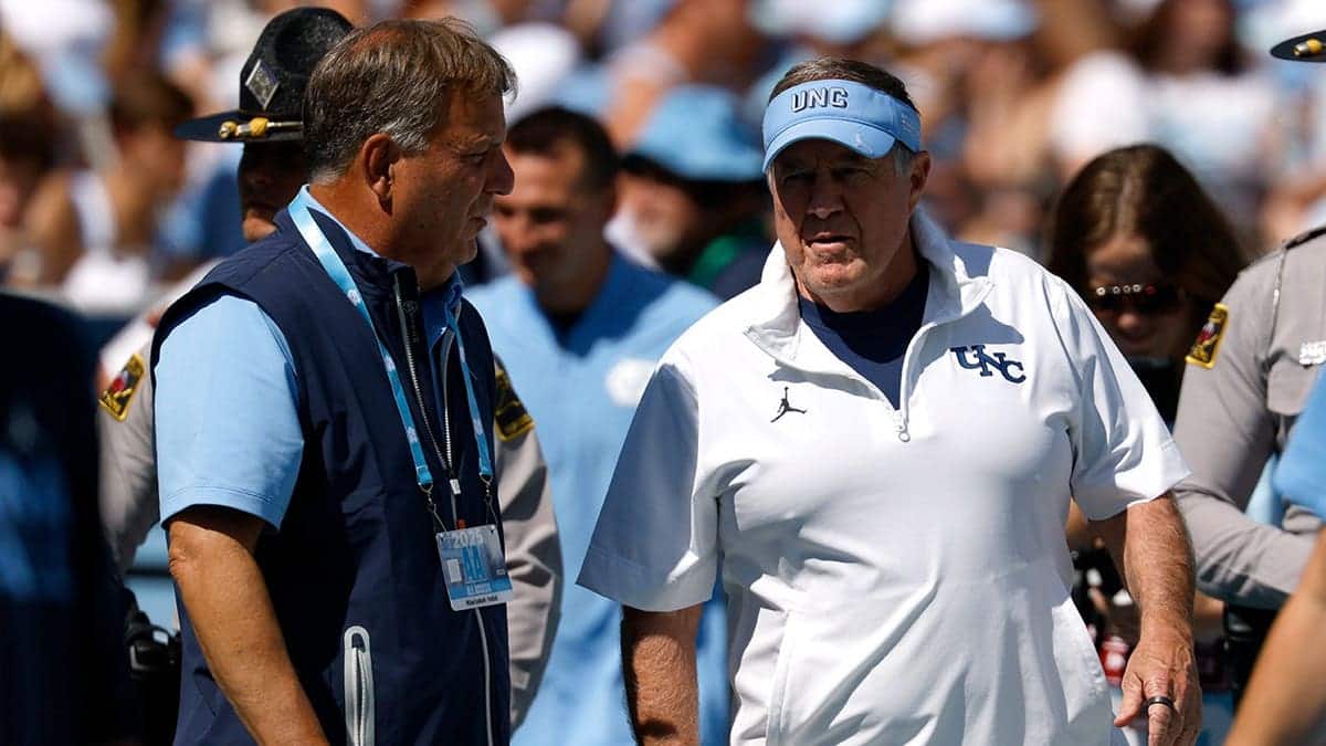 Michael Lombardi and Bill Belichick talk before UNC football game