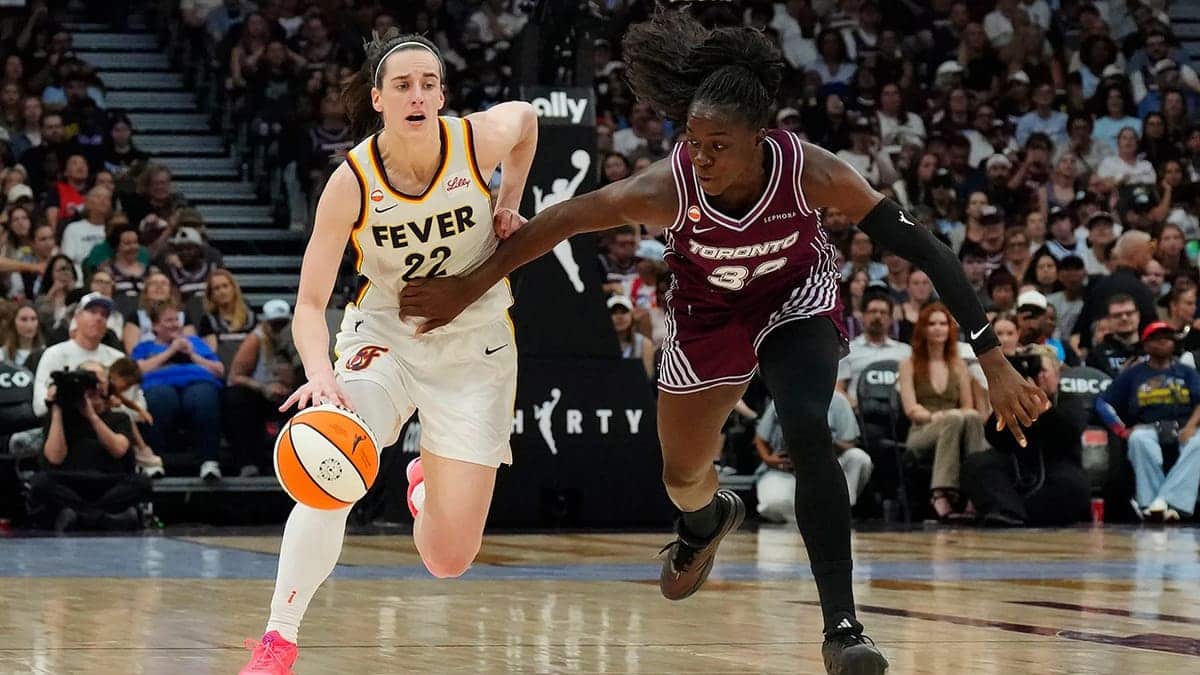 Caitlin Clark drives to the basket during a WNBA game