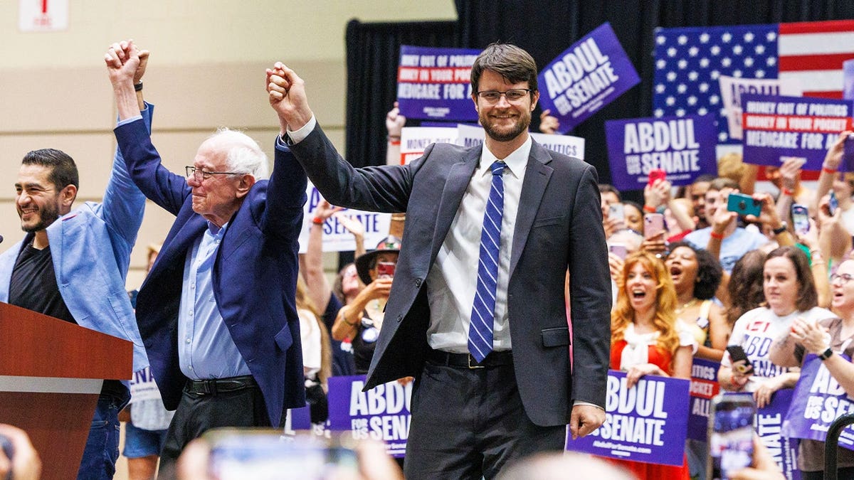 U.S. Senate candidate Abdul El-Sayed, left, U.S. Sen. Bernie Sanders, center, and U.S. House candidate William Lawrence, right, at a rally in Lansing, Mich., on July 19, 2026.