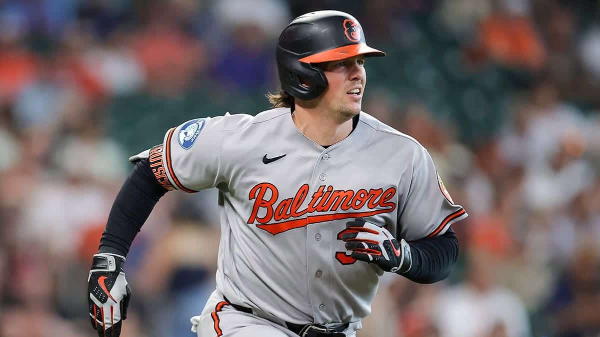 Adley Rutschman of the Baltimore Orioles runs to first base during a game against the Houston Astros.