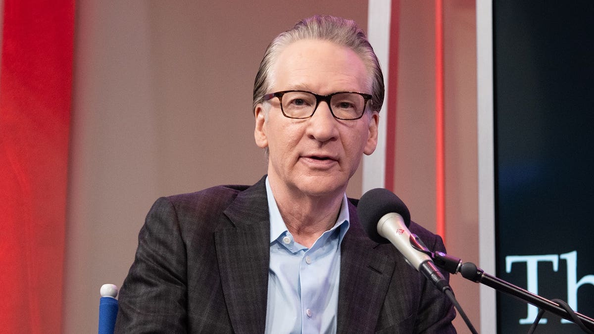 Bill Maher speaking into a microphone