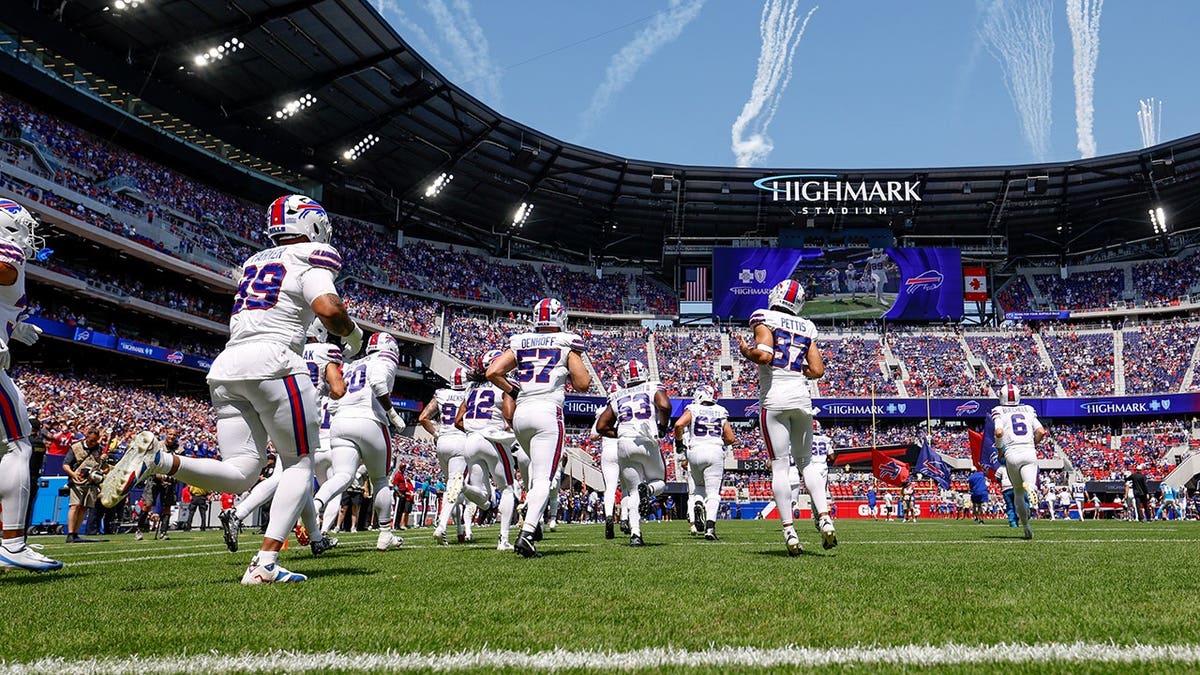 Buffalo Bills members take the field at Highmark Stadium in Orchard Park, New York.