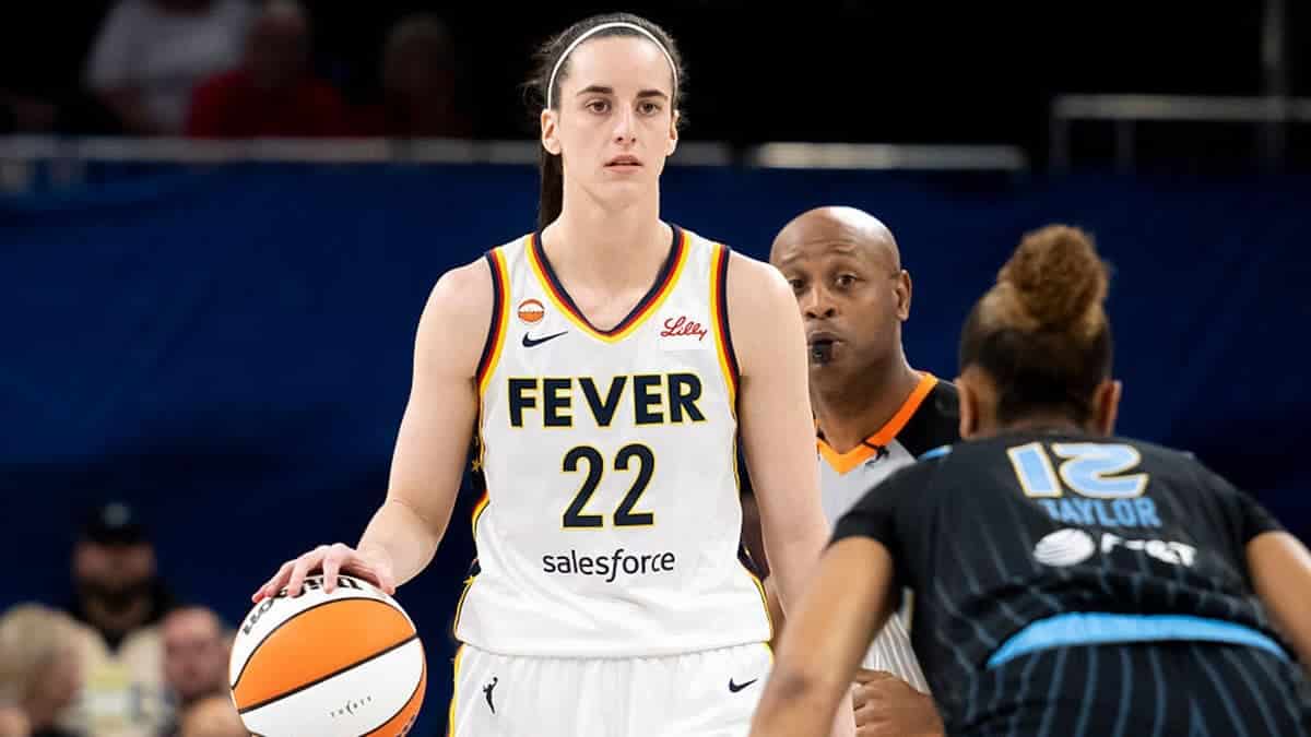 Caitlin Clark dribbles the ball against Sydney Taylor during a WNBA game.