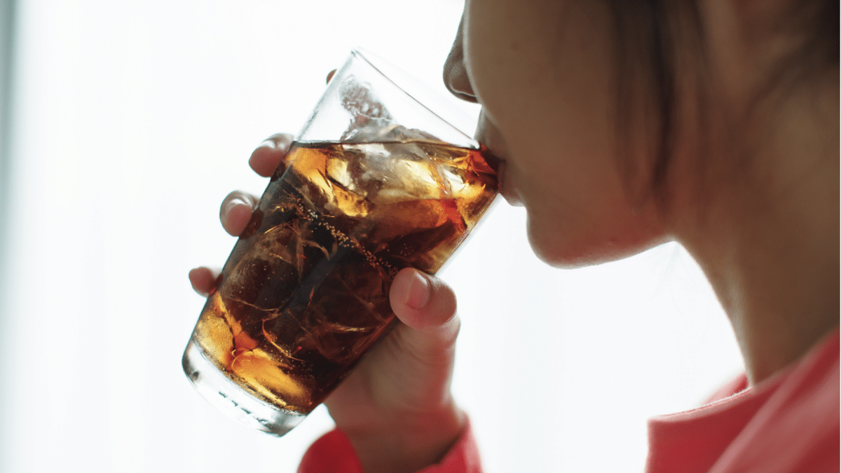 Woman drinking soda out of glass