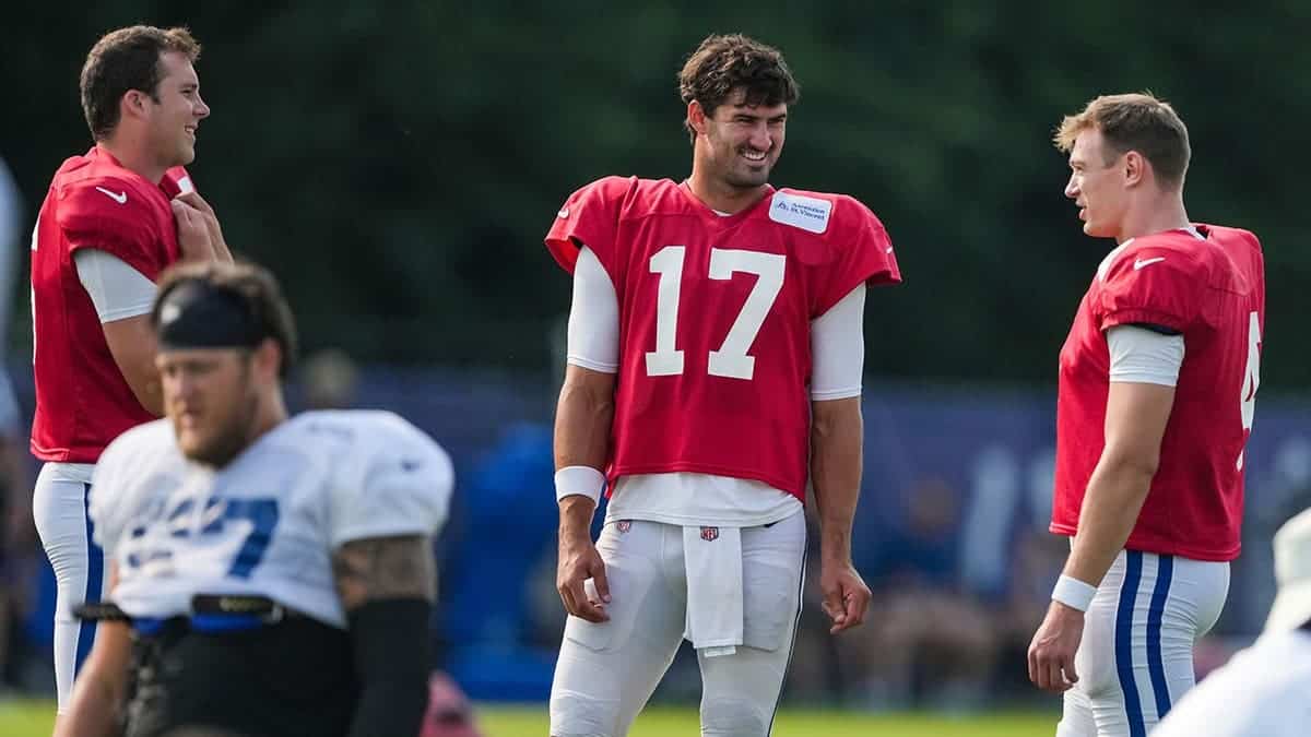 Daniel Jones smiles while talking with Easton Stick and Riley Leonard during Colts Camp practice.
