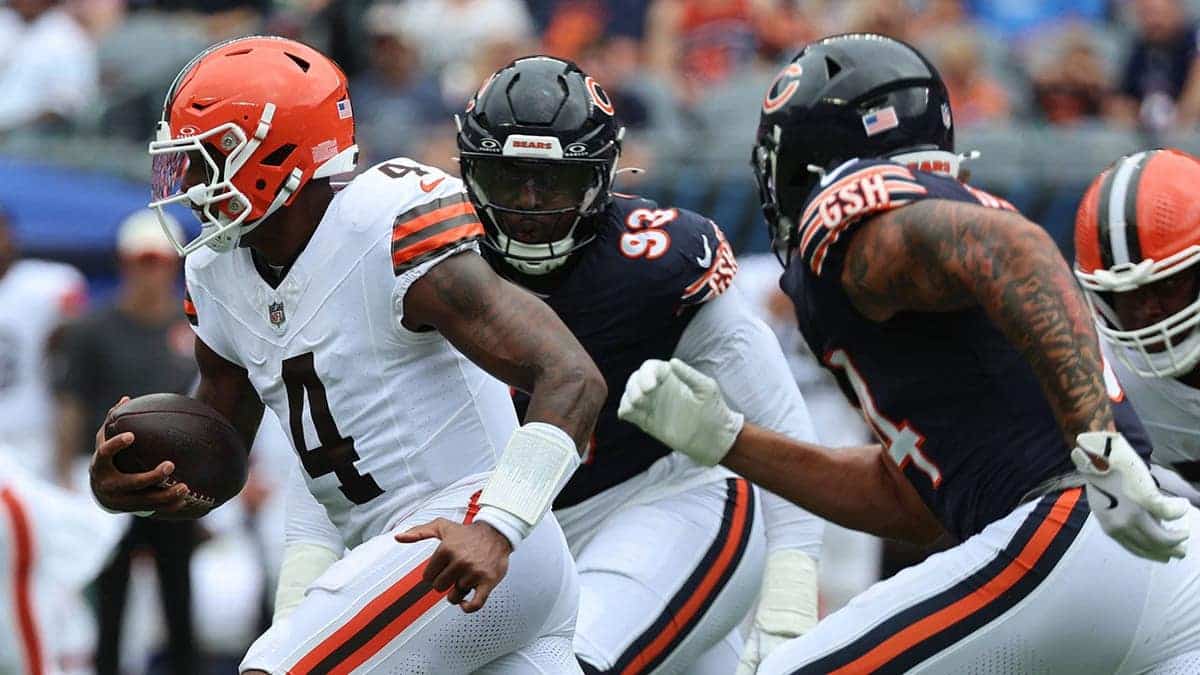 Deshaun Watson rushes the ball past Kentavius Street during an NFL game.