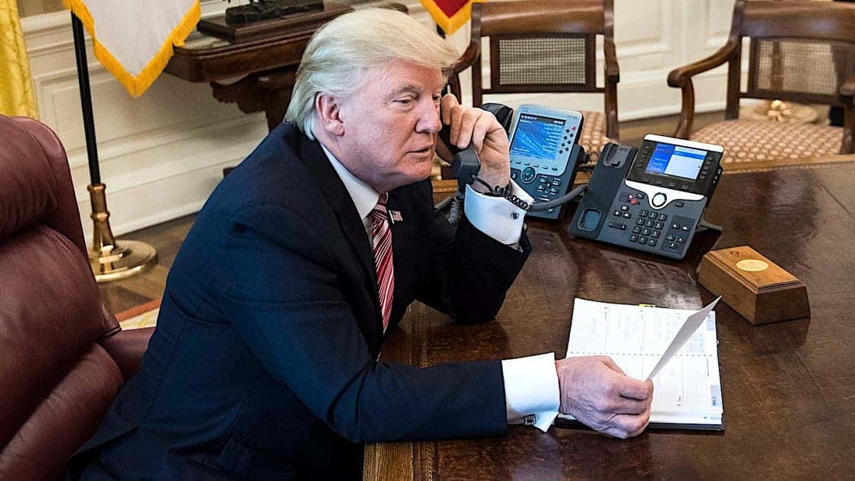 President Donald Trump talks on the phone in the Oval Office