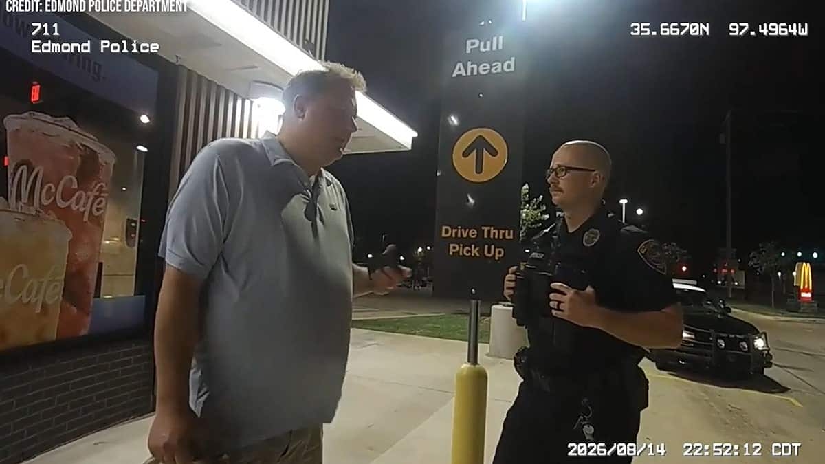 Oklahoma Secretary of State Benjamin Lepak speaks to Edmond police on Aug. 14, 2026, as officers question him outside a McDonald's.