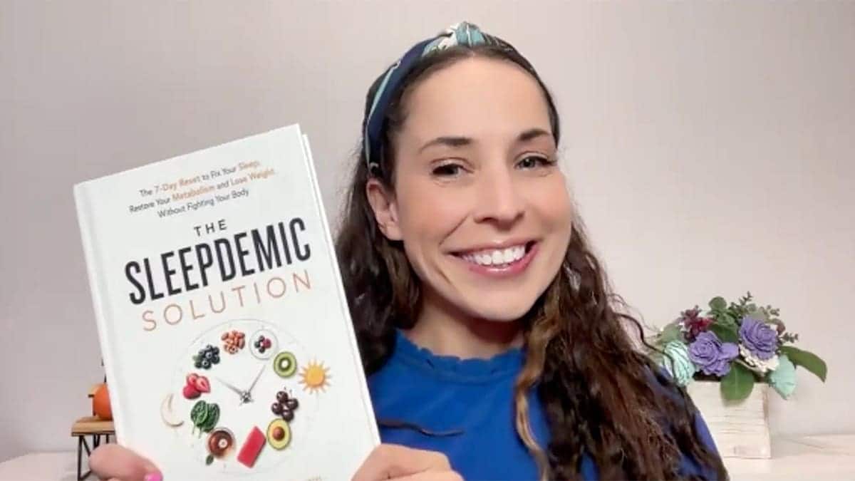 erin palinski wade holds up book