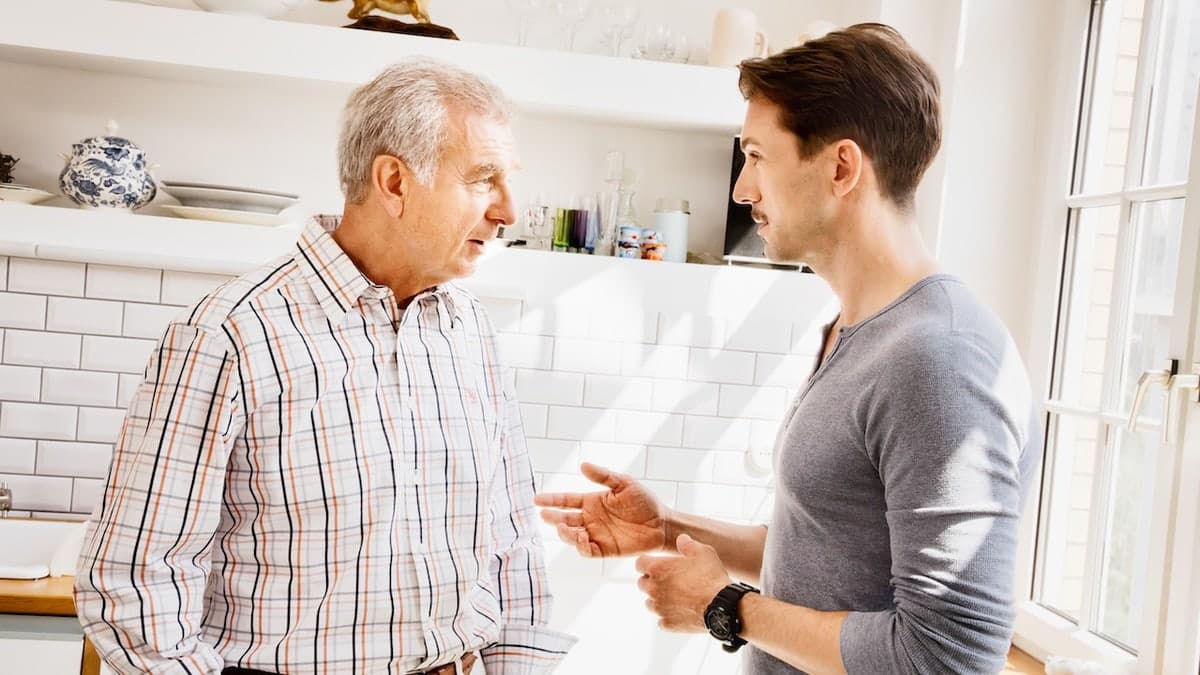 Father and son talking in kitchen