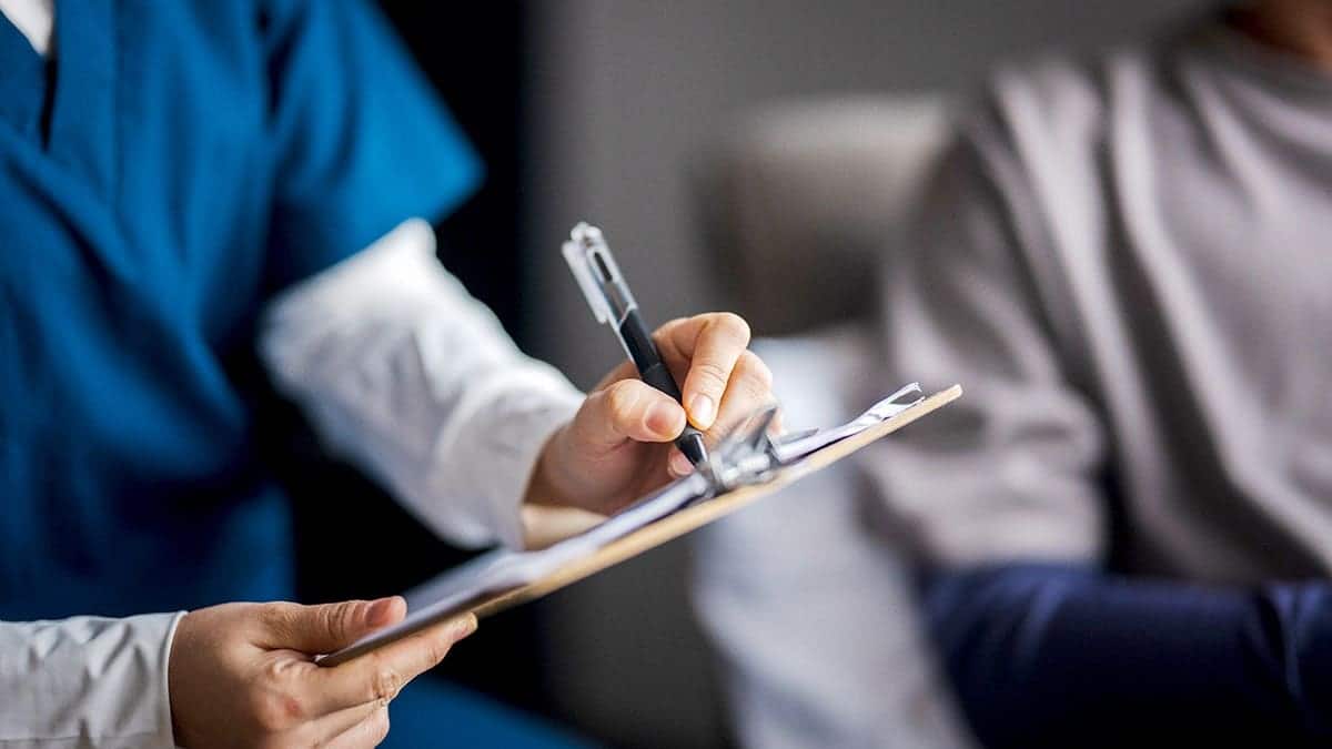 Female doctor consulting with a patient and pharmacist.