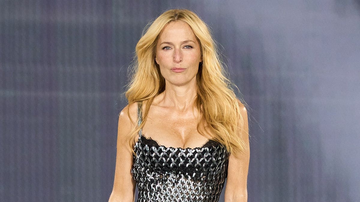 Gillian Anderson walks the runway in a L'Oréal Paris show during Paris Fashion Week.