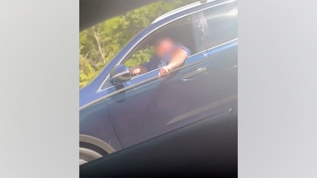 Dunn records a driver leaning out of a vehicle on a highway while her son cries.