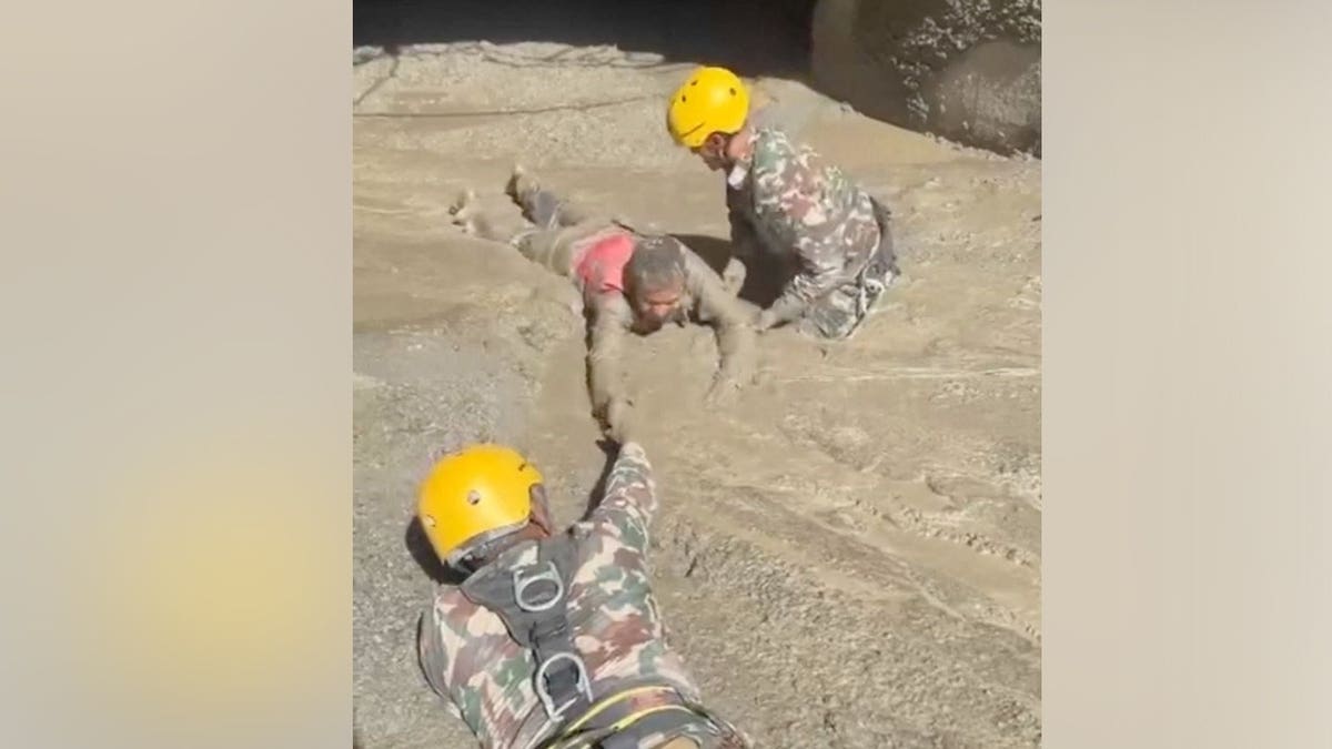 Rescuers evacuate a person from a tunnel of a hydropower project, in the aftermath of flash floods and a mudslide, in Rasuwa, Nepal, in this still image from handout video released August 28, 2026.