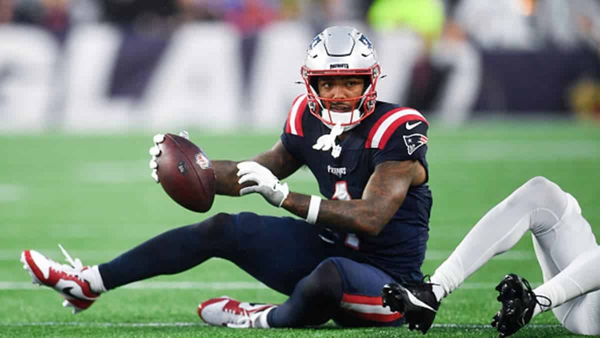 Ja'Lynn Polk #1 of the New England Patriots gets a first down during a preseason game.