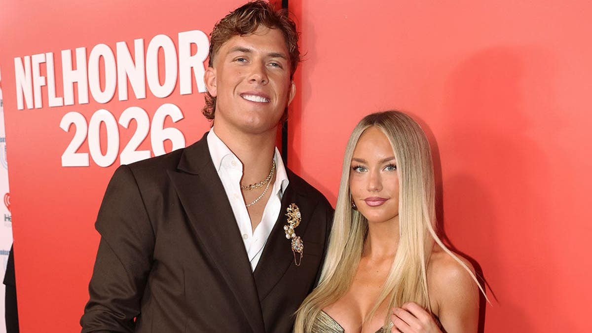 Jaxson Dart and Marissa Ayers stand at the NFL Honors event.