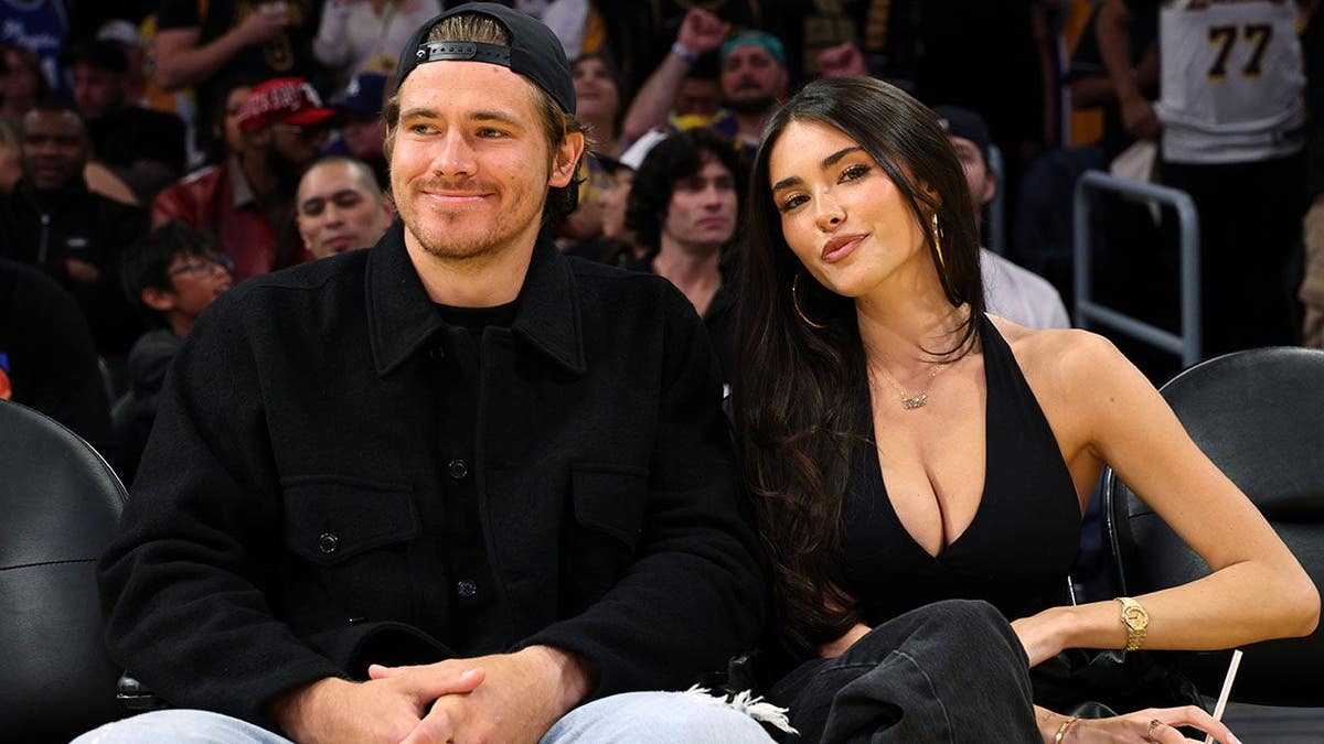 Quarterback Justin Herbert and Madison Beer attending a basketball game at Crypto.com Arena