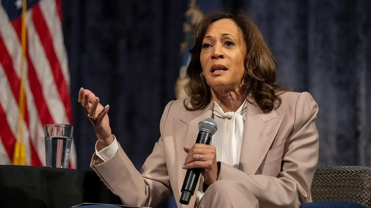 Former Vice President Kamala Harris speaking at a podium in Detroit Michigan
