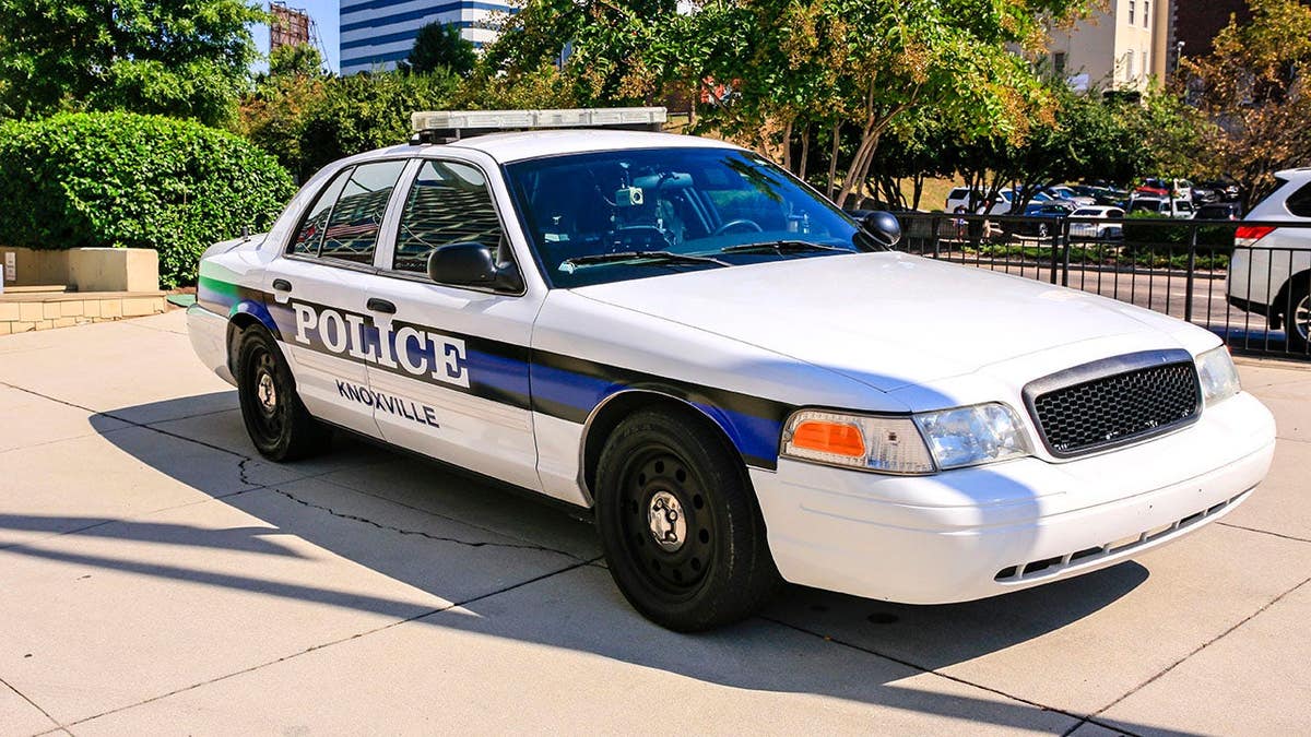 Blue and white Knoxville Police vehicle parked on street in Knoxville, Tenn.