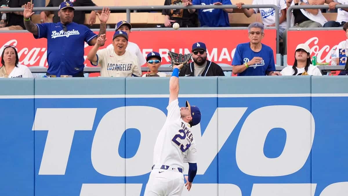 Los Angeles Dodgers right fielder Kyle Tucker catching a baseball during a game.