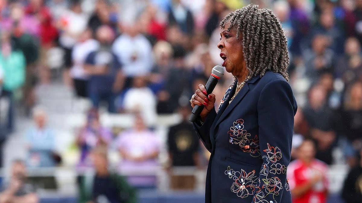 Martha Reeves sings the national anthem before a Women's Pro Baseball League game.