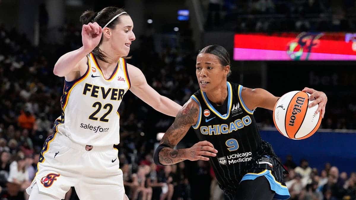 Natasha Cloud drives against Caitlin Clark during a WNBA basketball game.