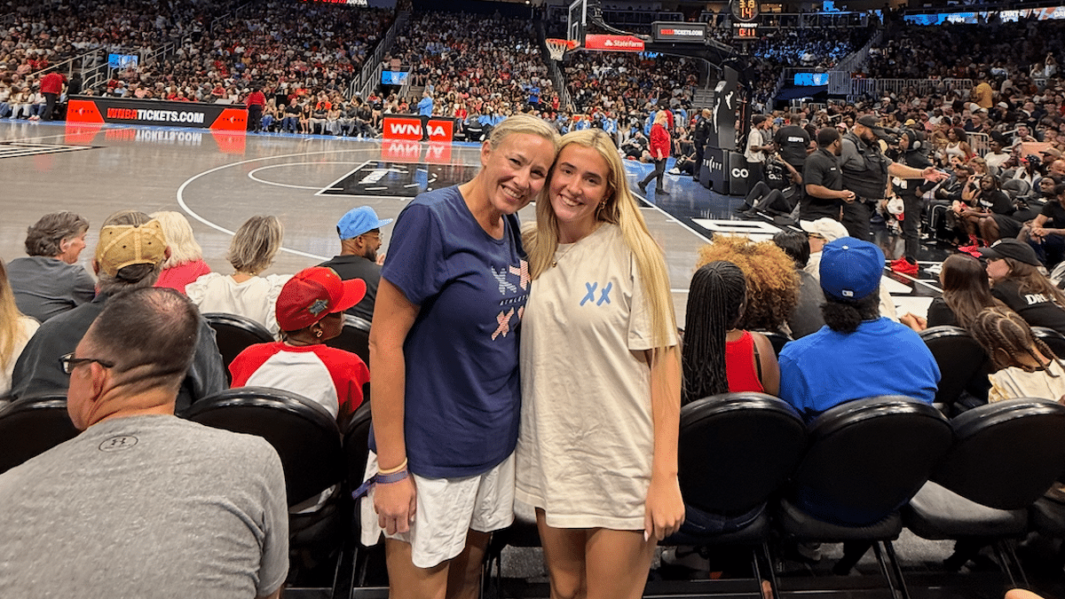 Kasey and Annie Thomason courtside in XX-XY t-shirts for Fever vs Dream 8/16/26