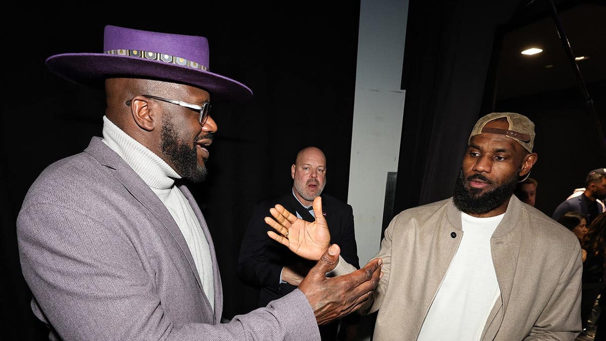 Shaquille O'Neal and LeBron James high five before the NBA All-Star Game.