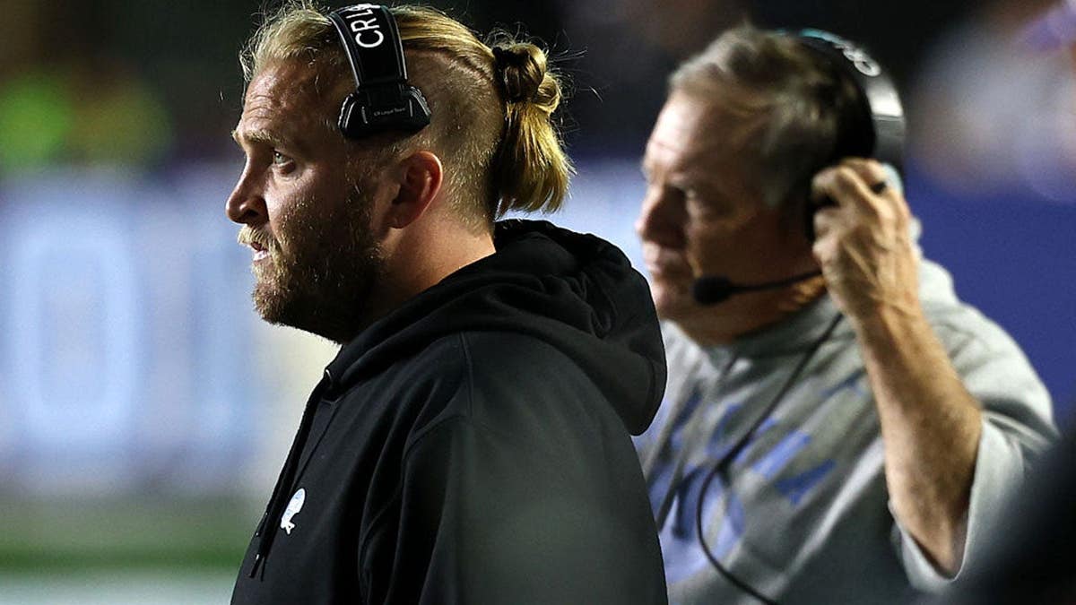Steve Belichick and Bill Belichick look on during a game at Kenan Stadium.