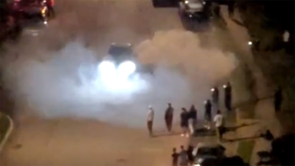 Police say vehicles performed donuts and burnouts as spectators gathered during a street takeover in Medford, New York, early Saturday, Aug. 15, 2026.