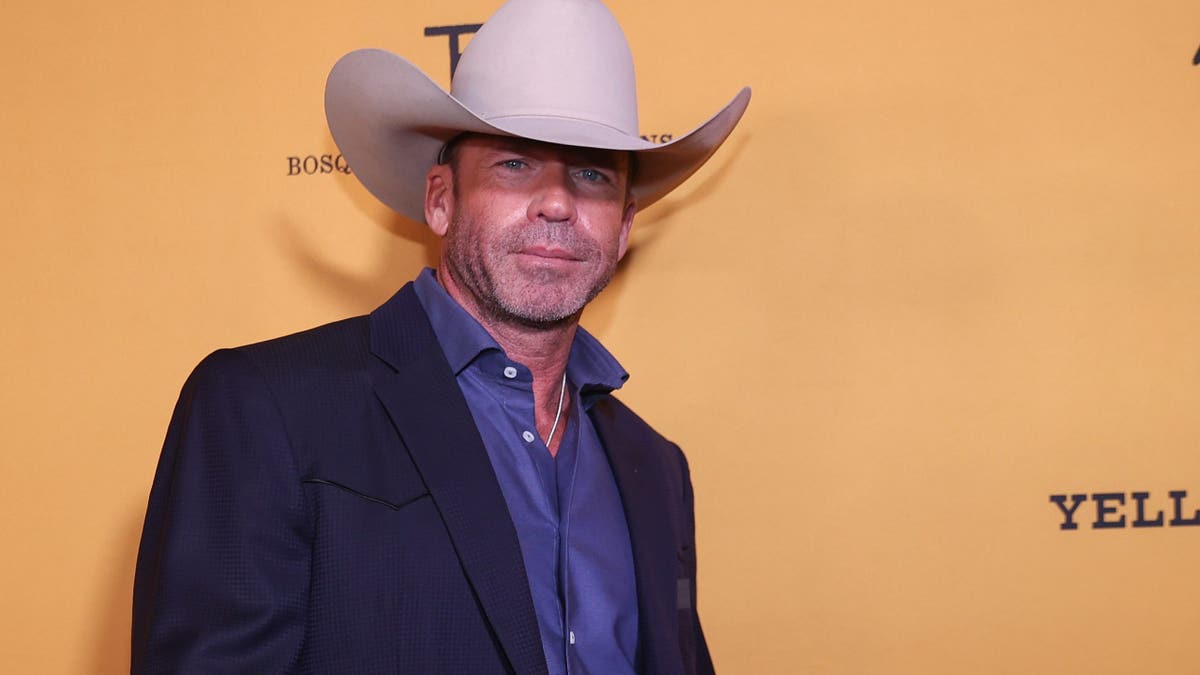 Taylor Sheridan standing on the black carpet at Yellowstone Season 5 Fort Worth premiere