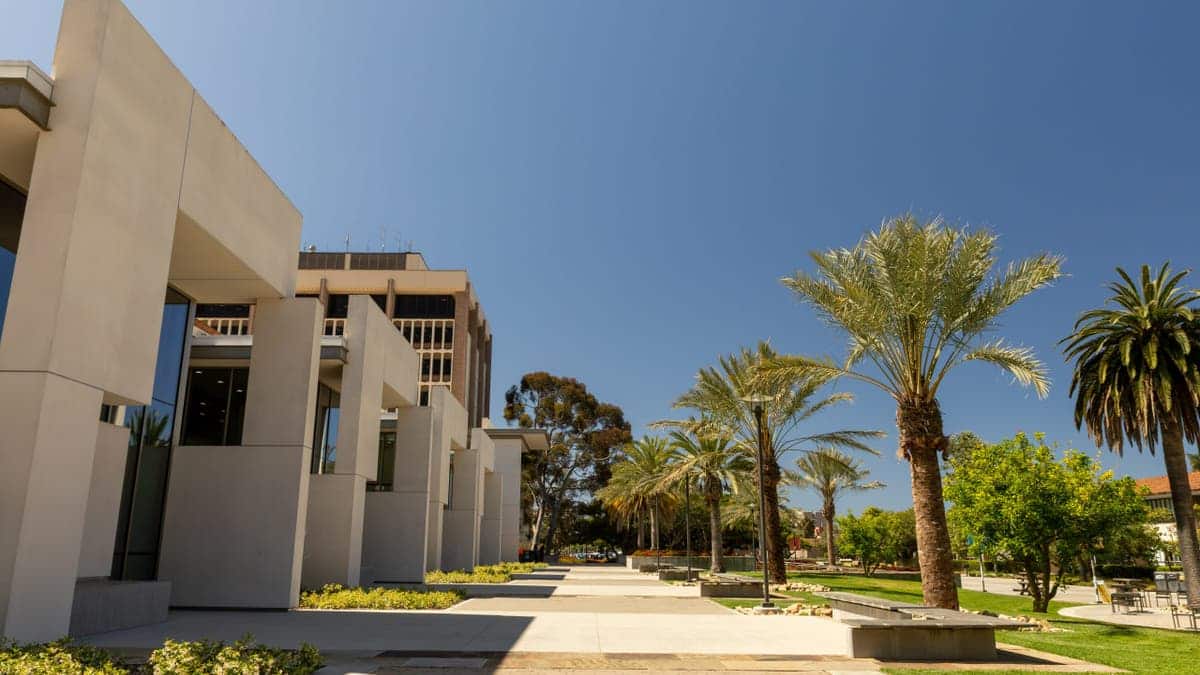 Student walking on a walkway at University of California Santa Barbara campus