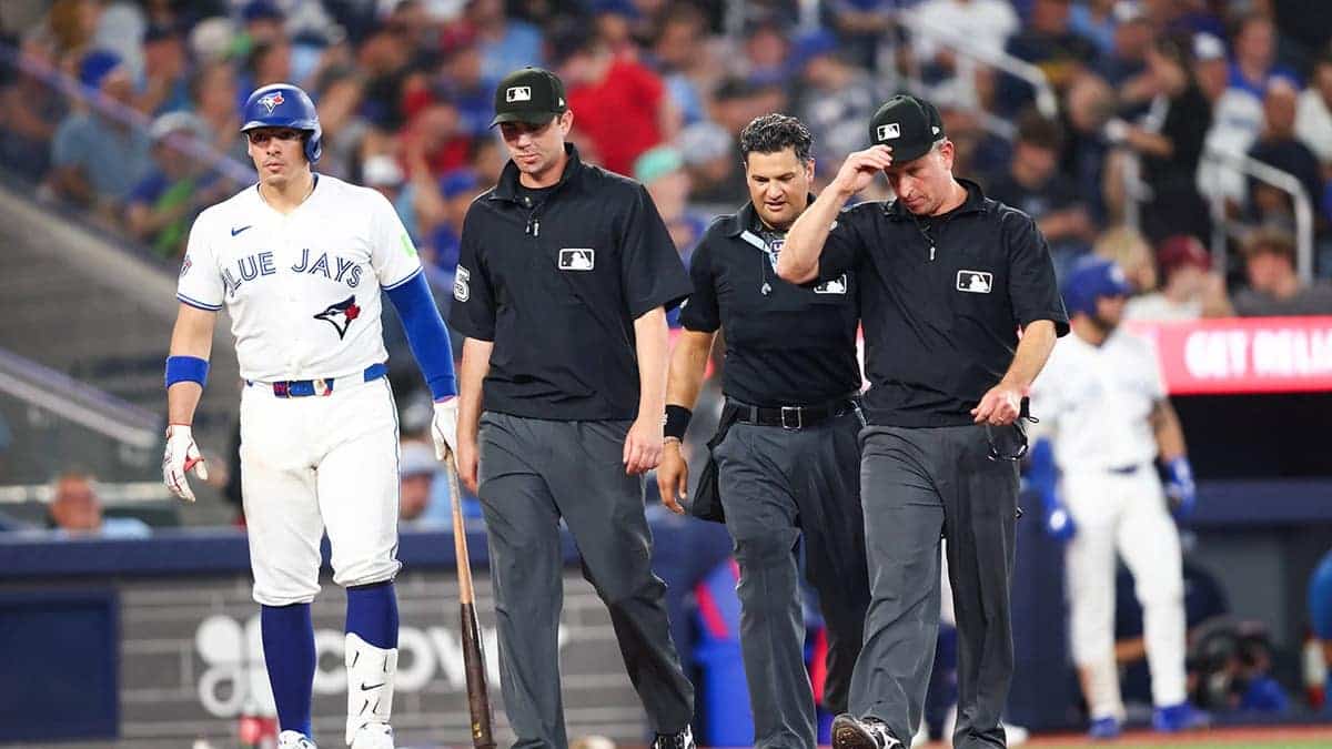 Umpires gather to review a play during an MLB game at Rogers Centre.