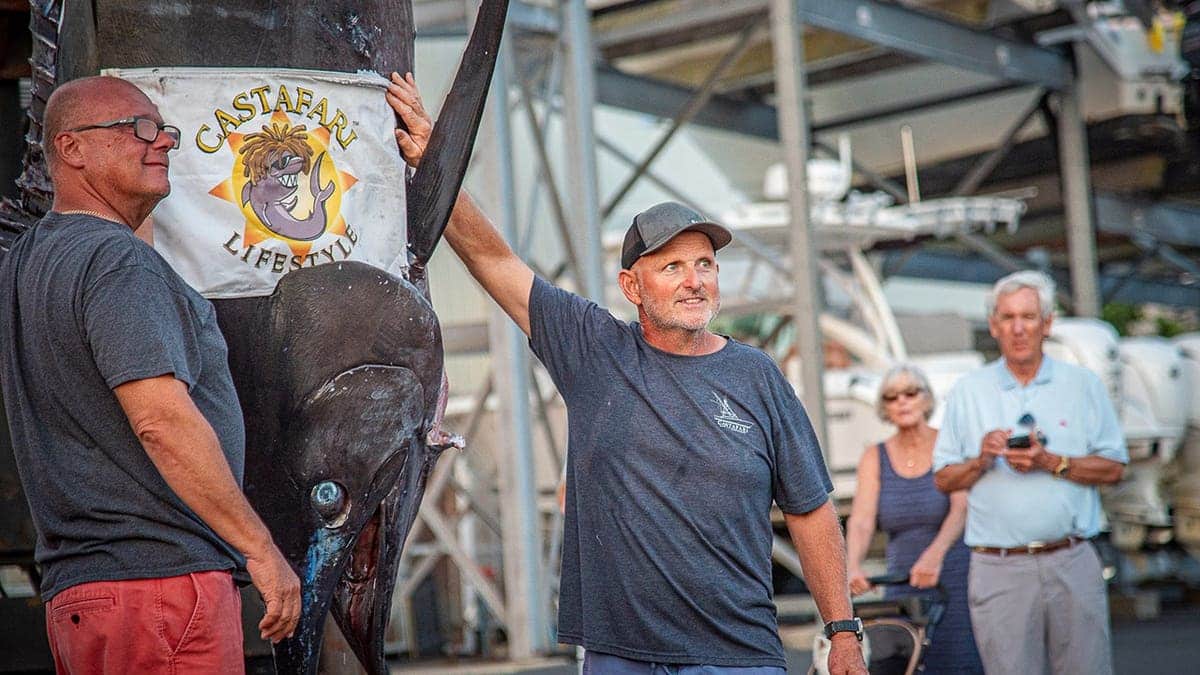 Walter Chapman and Damon Sacco pose with a large blue marlin they caught off Massachusetts.