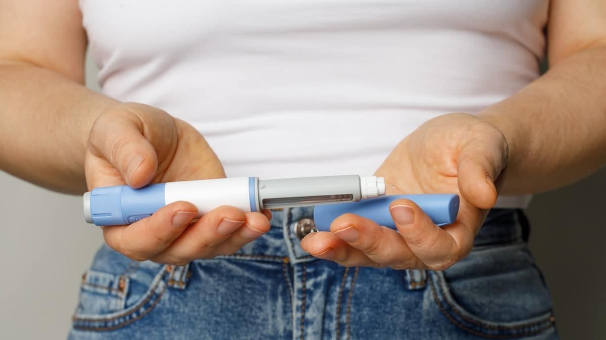 Woman holding weight-loss injection