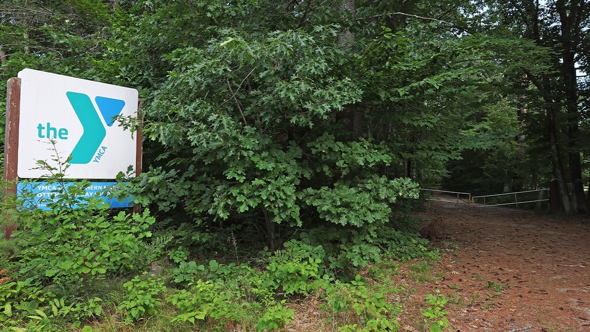 ymca logo in front of trees