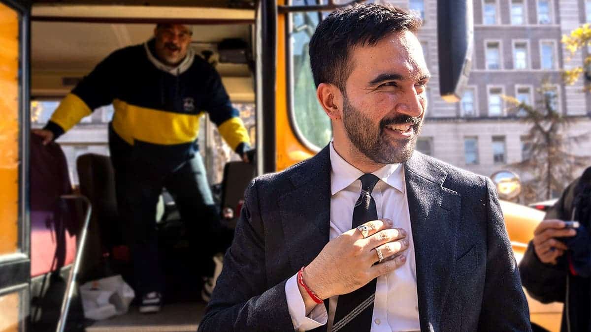 Zohran Mamdani greets bus driver during New York City campaign event.