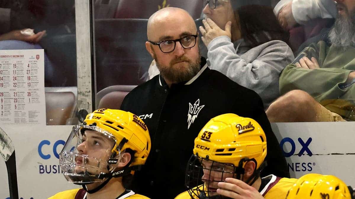 Greg Powers sits on the bench during a game at Mullett Arena.