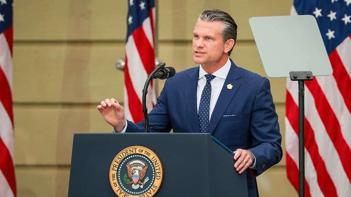 Secretary of War Pete Hegseth speaking to a crowd.